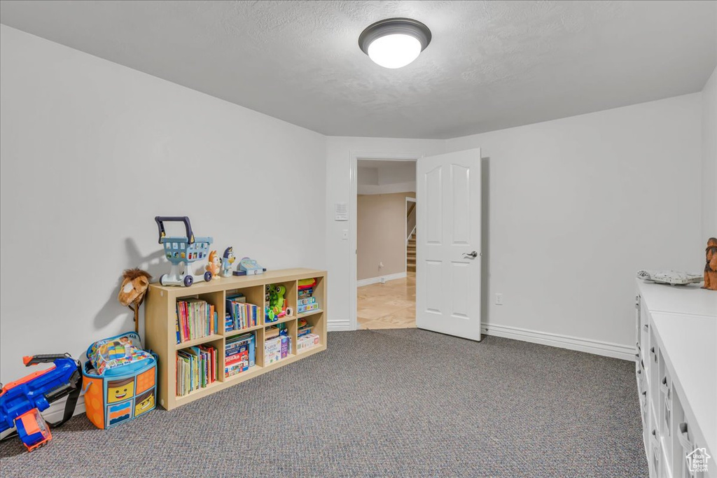 Recreation room featuring carpet and baseboards