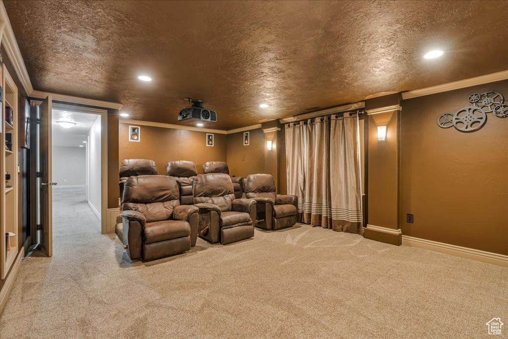 Home theater room with carpet floors, crown molding, recessed lighting, and baseboards