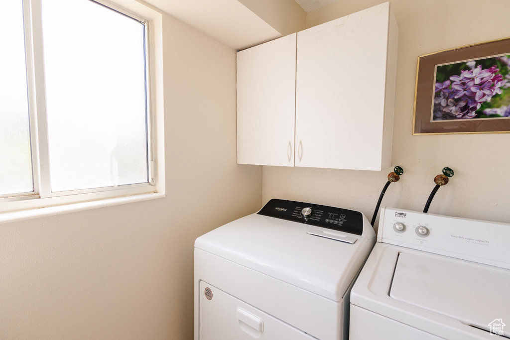 Laundry room featuring cabinet space and washing machine and dryer