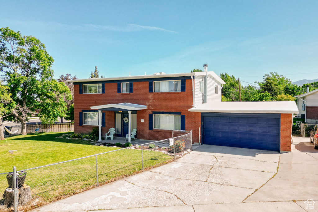 View of front of house with driveway and brick siding