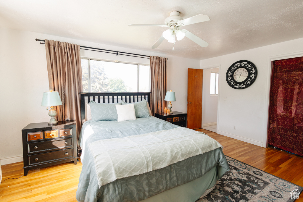 Bedroom featuring wood finished floors, baseboards, and ceiling fan