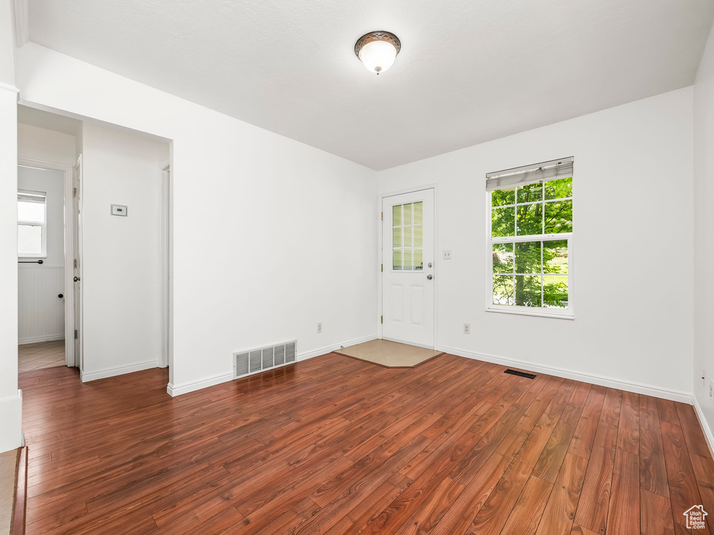 Empty room featuring wood-type flooring and baseboards