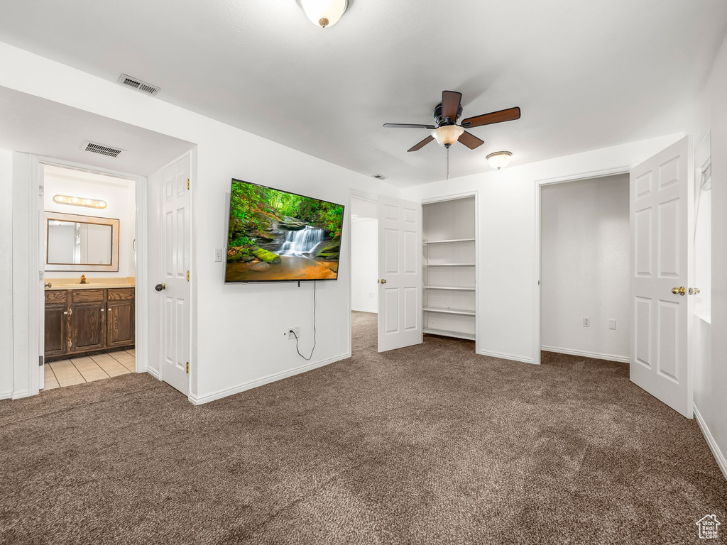 Unfurnished bedroom featuring carpet, baseboards, and ensuite bathroom
