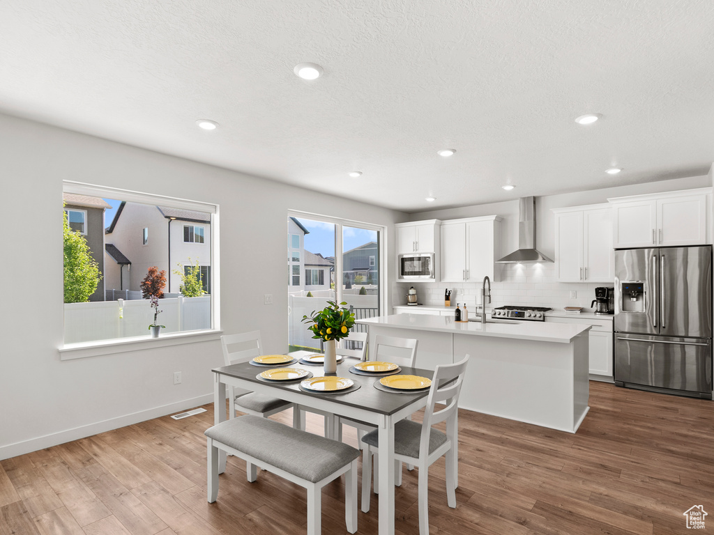 Dining room featuring wood finished floors, recessed lighting, and baseboards