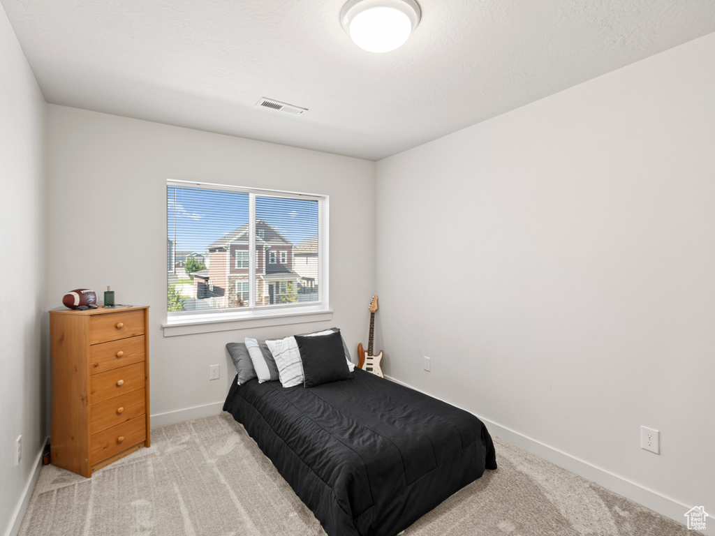 Bedroom with carpet floors and baseboards