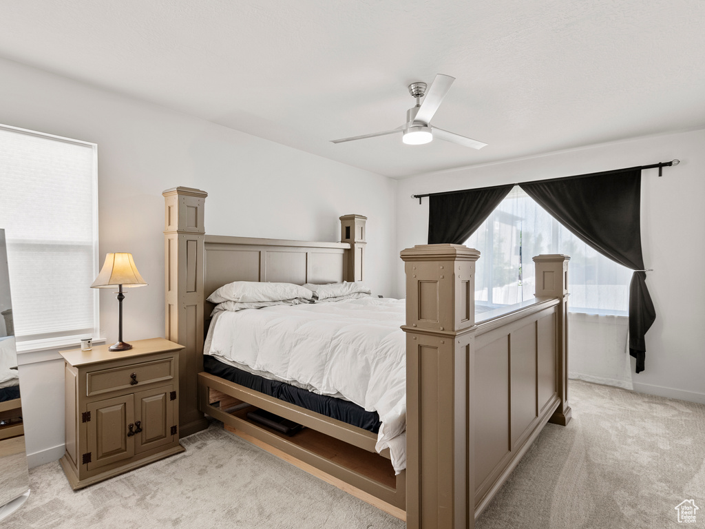 Bedroom featuring light carpet and a ceiling fan