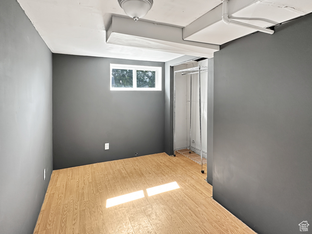 Unfurnished bedroom with wood finished floors