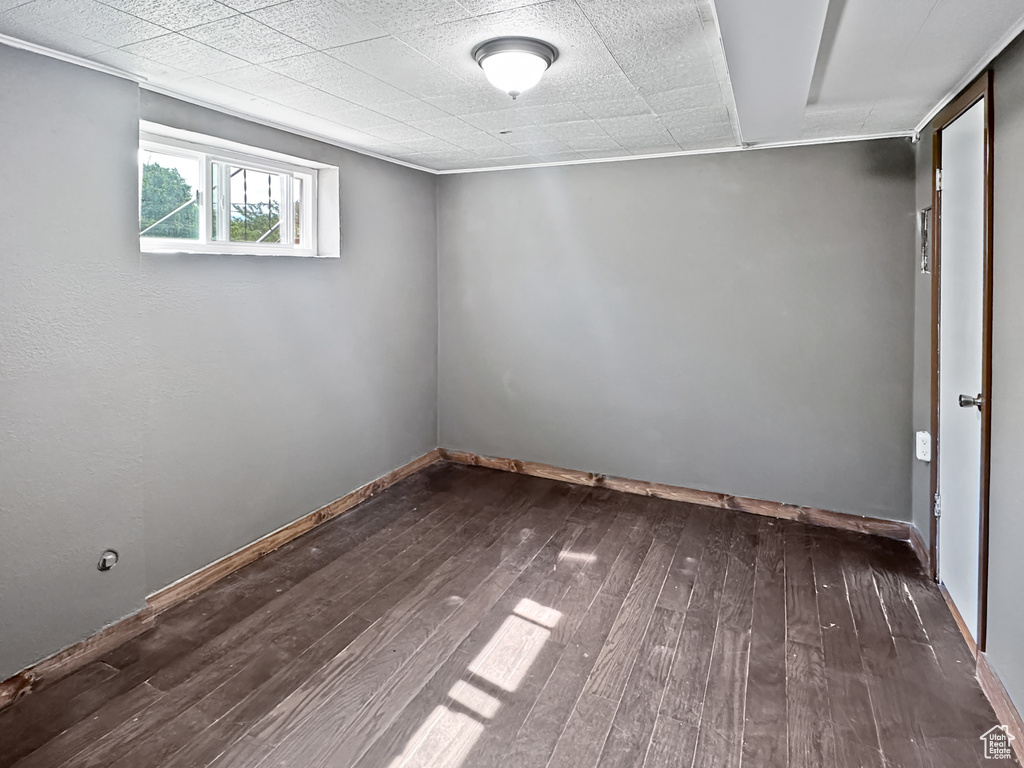 Below grade area featuring dark wood-style floors and baseboards