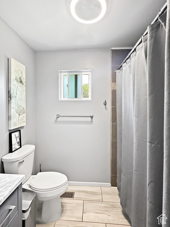 Full bathroom with vanity, toilet, and a shower with shower curtain