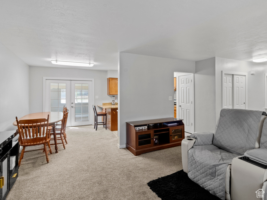 Living room with light colored carpet and french doors