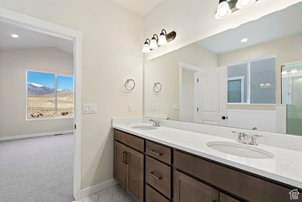Bathroom with double vanity, baseboards, a mountain view, and an enclosed shower