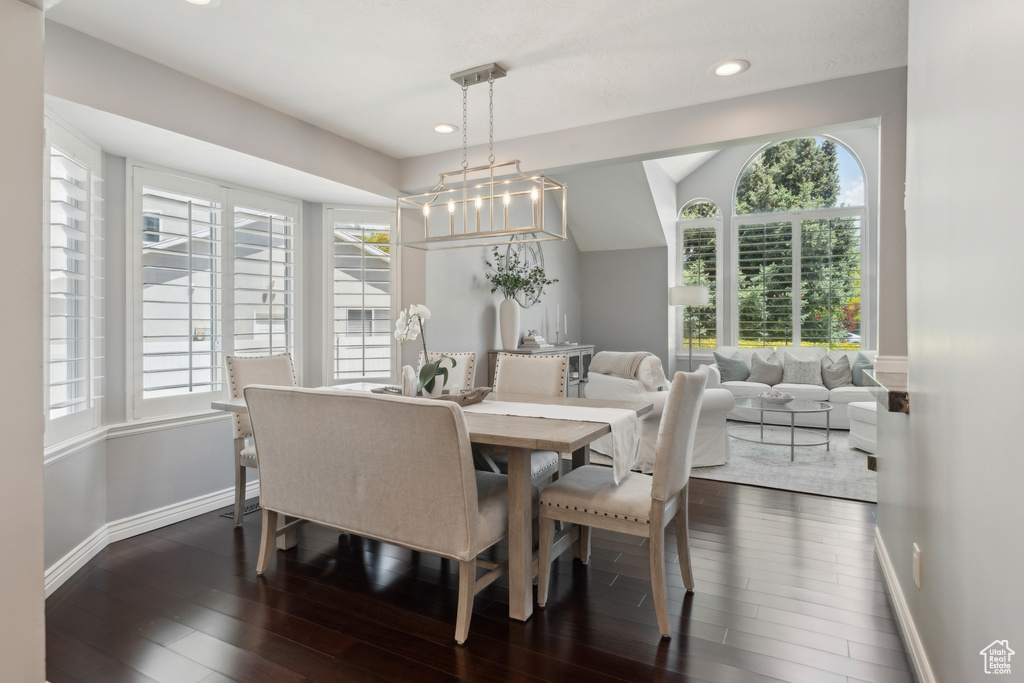 Dining space with dark wood-type flooring, plenty of natural light, baseboards, and recessed lighting