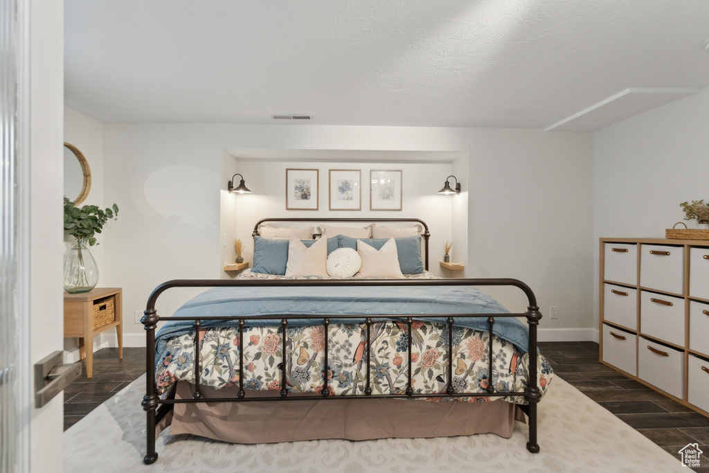 Bedroom with baseboards and wood finished floors