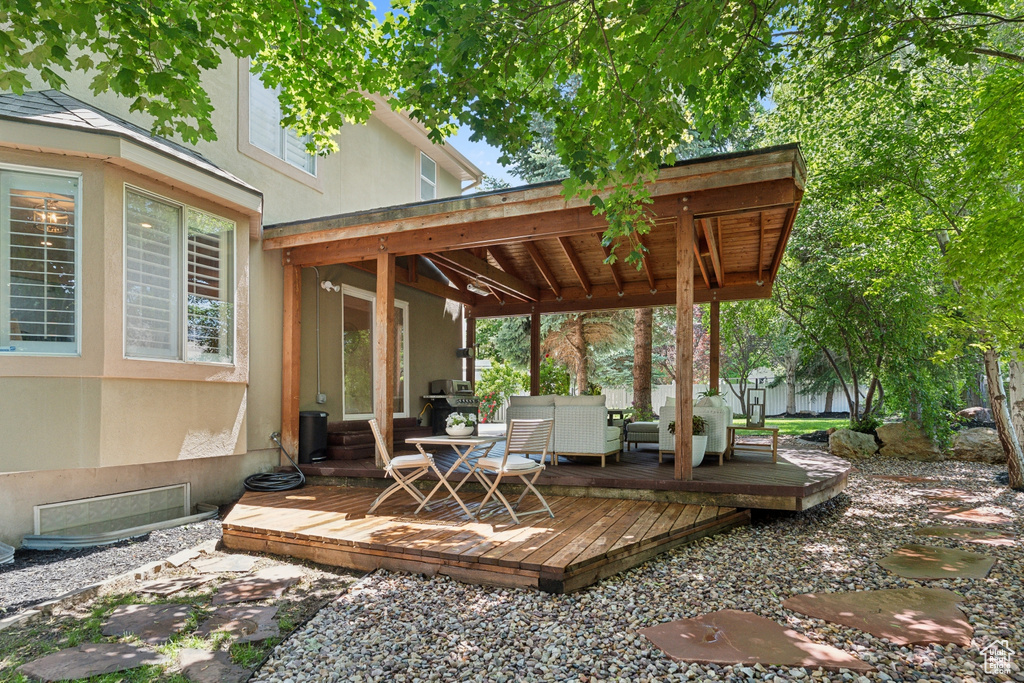 Deck with a grill and an outdoor hangout area