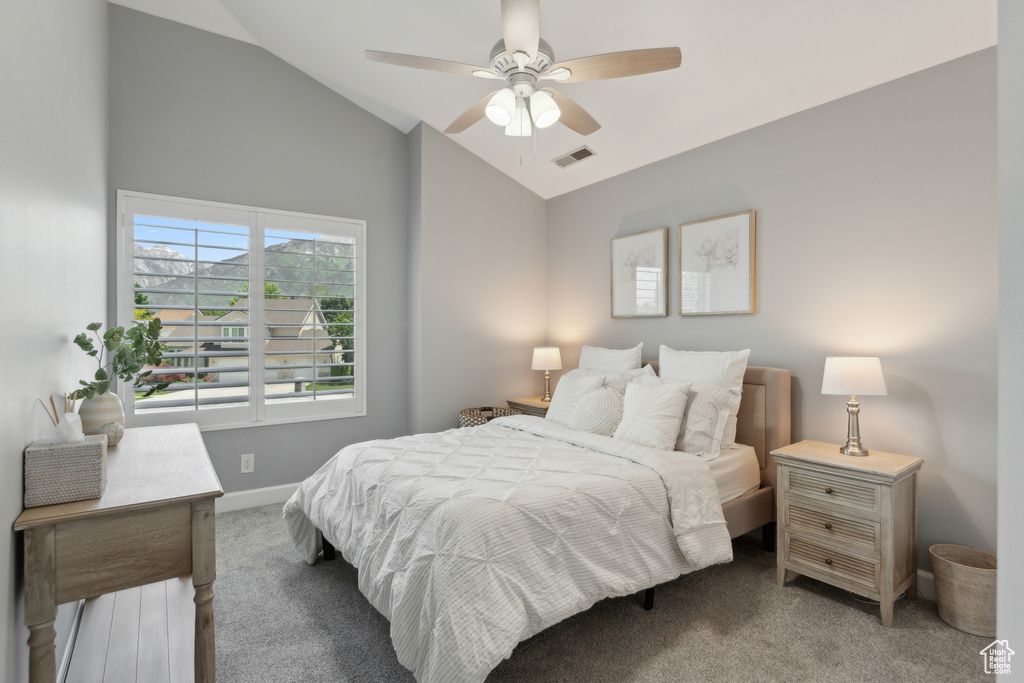 Bedroom featuring lofted ceiling, carpet flooring, baseboards, and ceiling fan