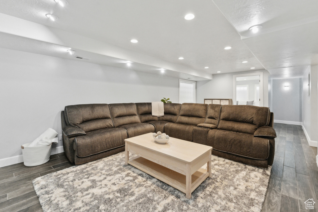 Living area featuring wood finished floors, baseboards, and recessed lighting