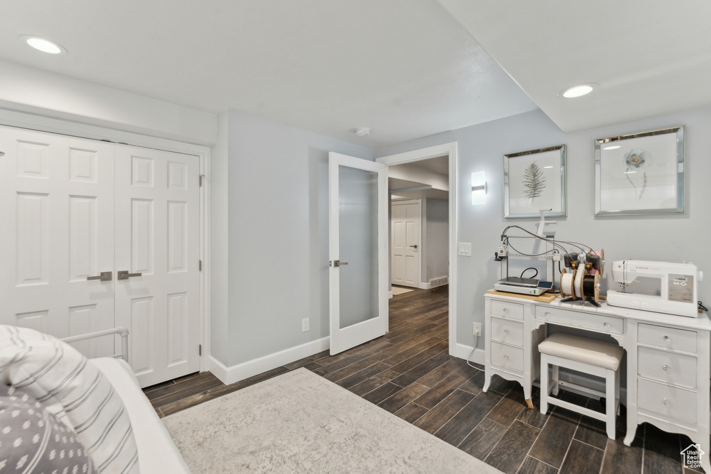 Bedroom with baseboards, dark wood-style floors, recessed lighting, a closet, and french doors