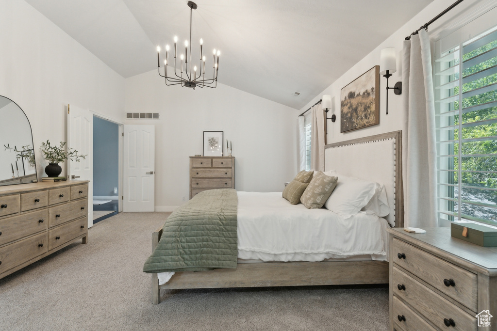 Carpeted bedroom featuring a chandelier, multiple windows, and high vaulted ceiling