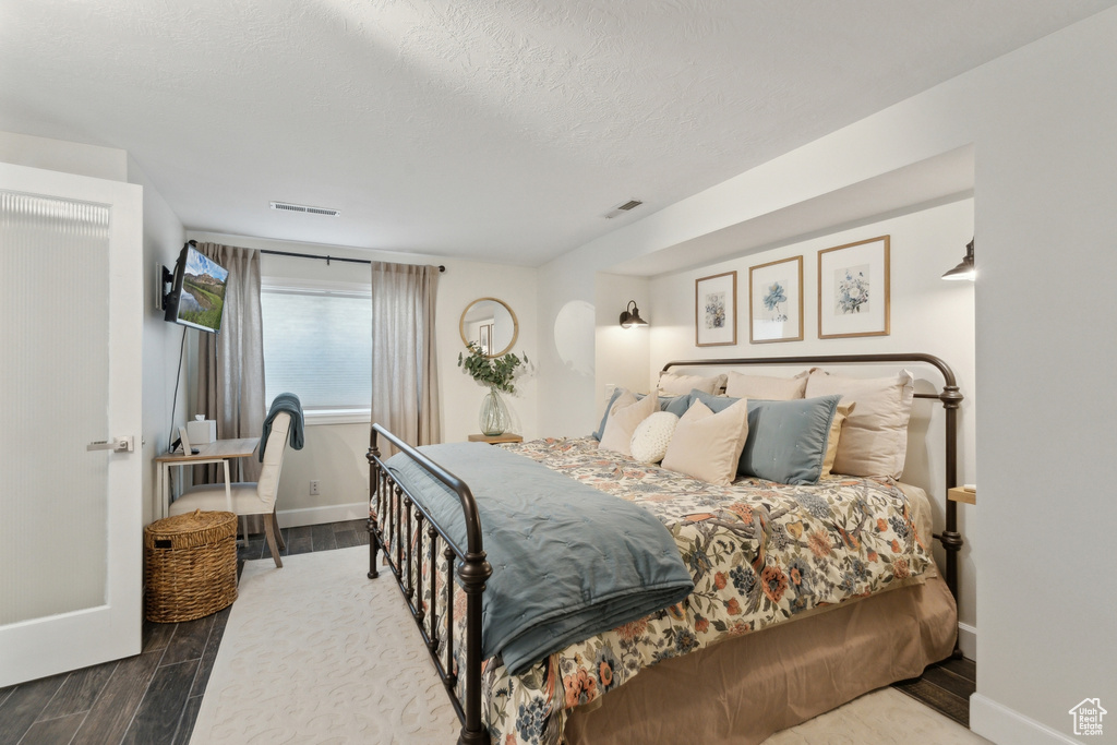 Bedroom featuring wood finished floors and baseboards