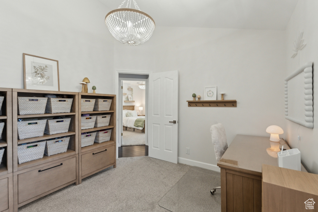 Carpeted office with a chandelier, a high ceiling, and baseboards