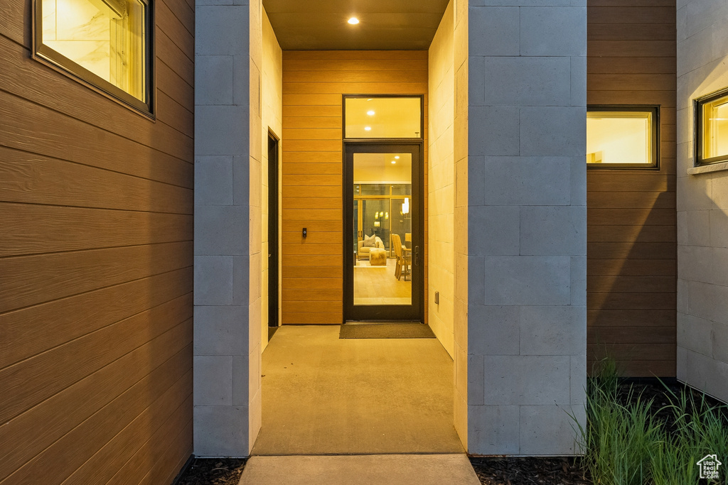 View of exterior entry featuring concrete block siding