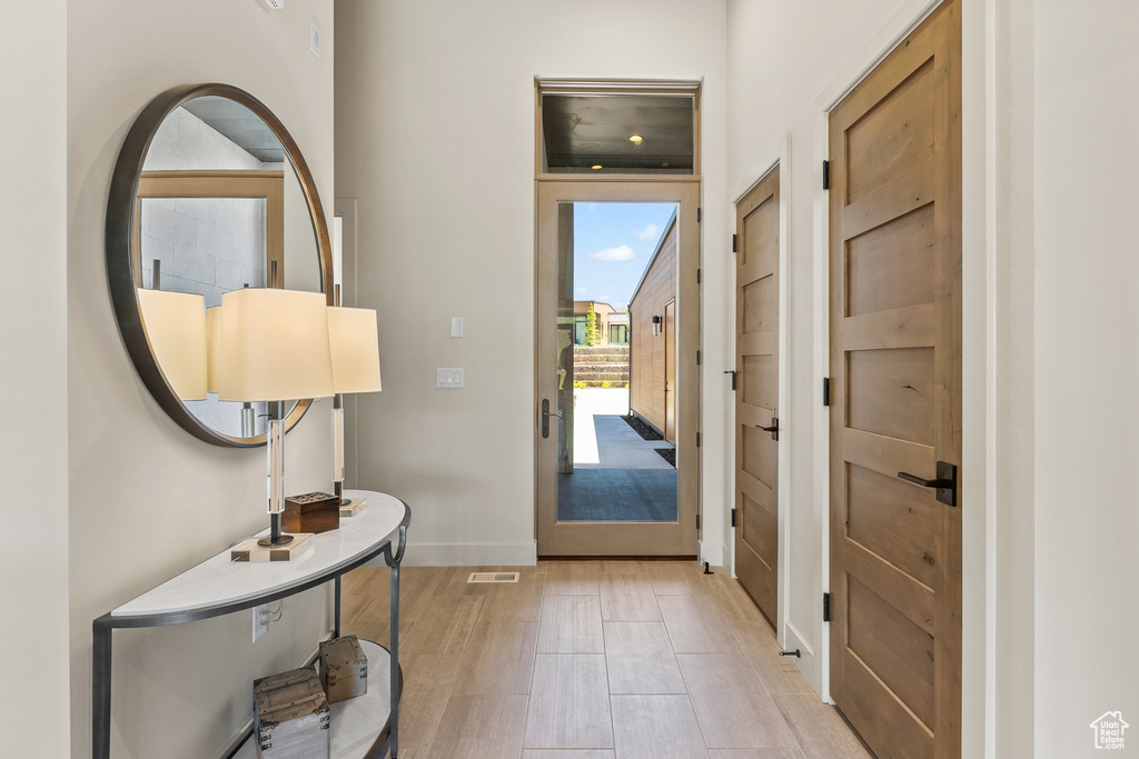 Entryway with light wood-style floors and baseboards