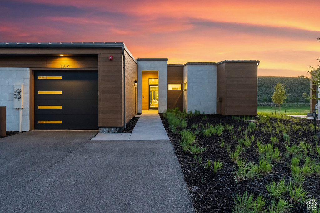 Modern home featuring asphalt driveway