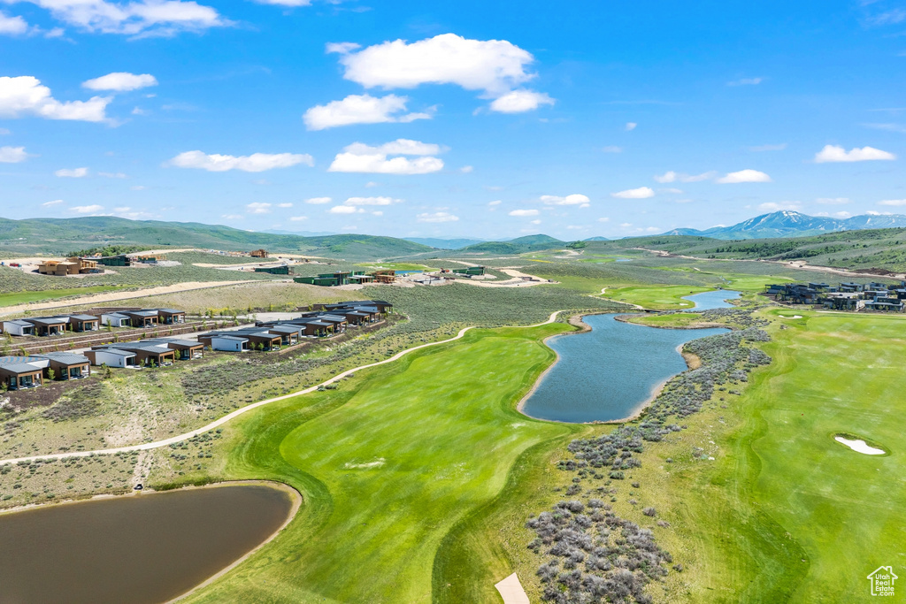 Aerial perspective of suburban area featuring a water and mountain view and a local golf course