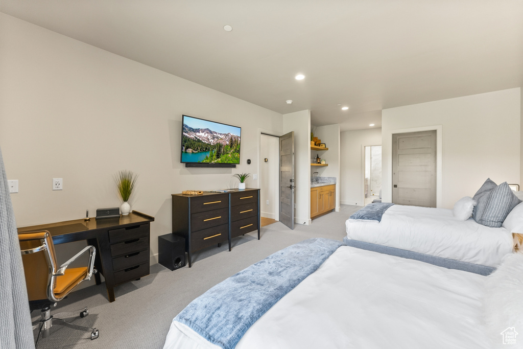 Bedroom with light carpet, a desk, and recessed lighting