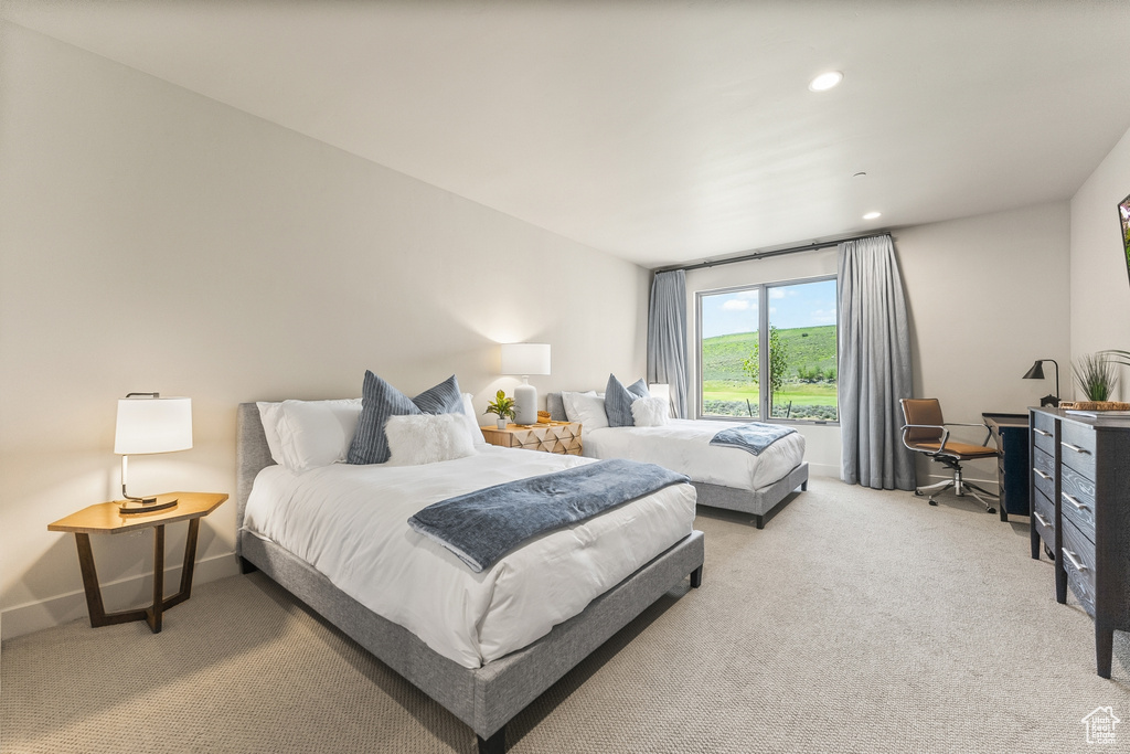 Bedroom with light colored carpet, an office area, baseboards, and recessed lighting