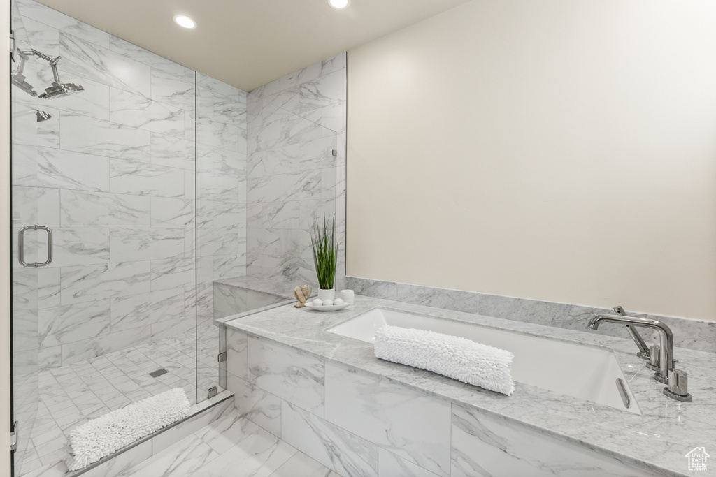 Bathroom with a marble finish shower, recessed lighting, a garden tub, and marble finish floors
