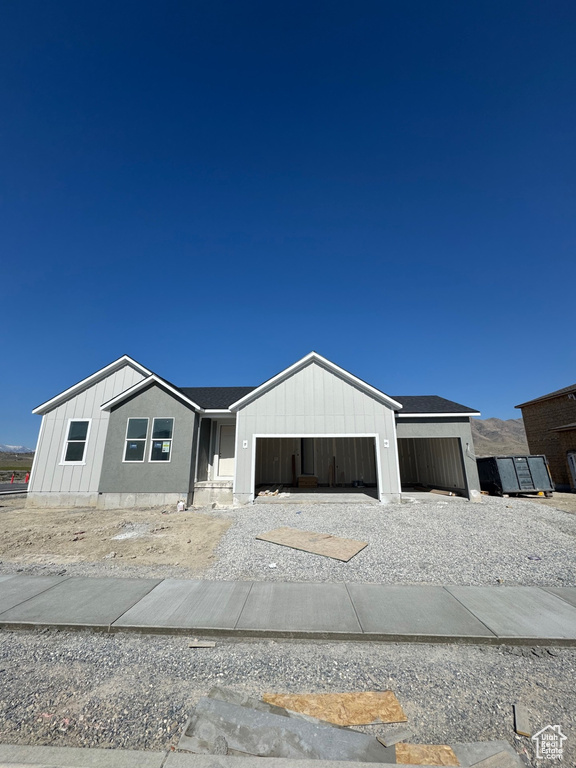 View of front facade featuring a garage and driveway