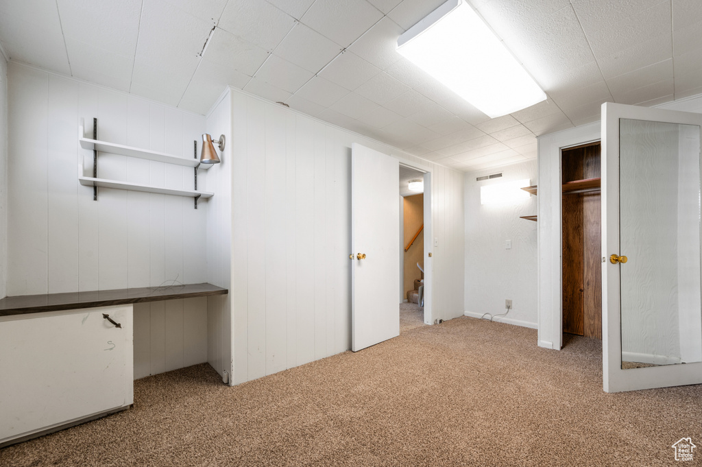 Finished basement with carpet floors and stairway