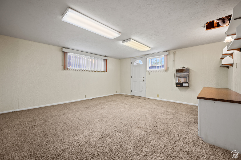 Below grade area with light carpet and baseboards