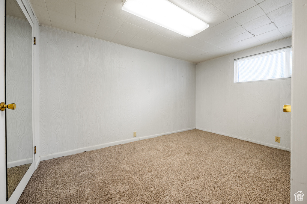 Carpeted spare room with baseboards