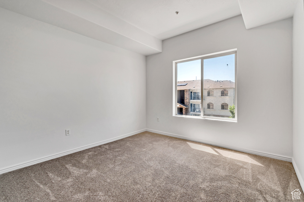 Empty room featuring carpet floors and baseboards