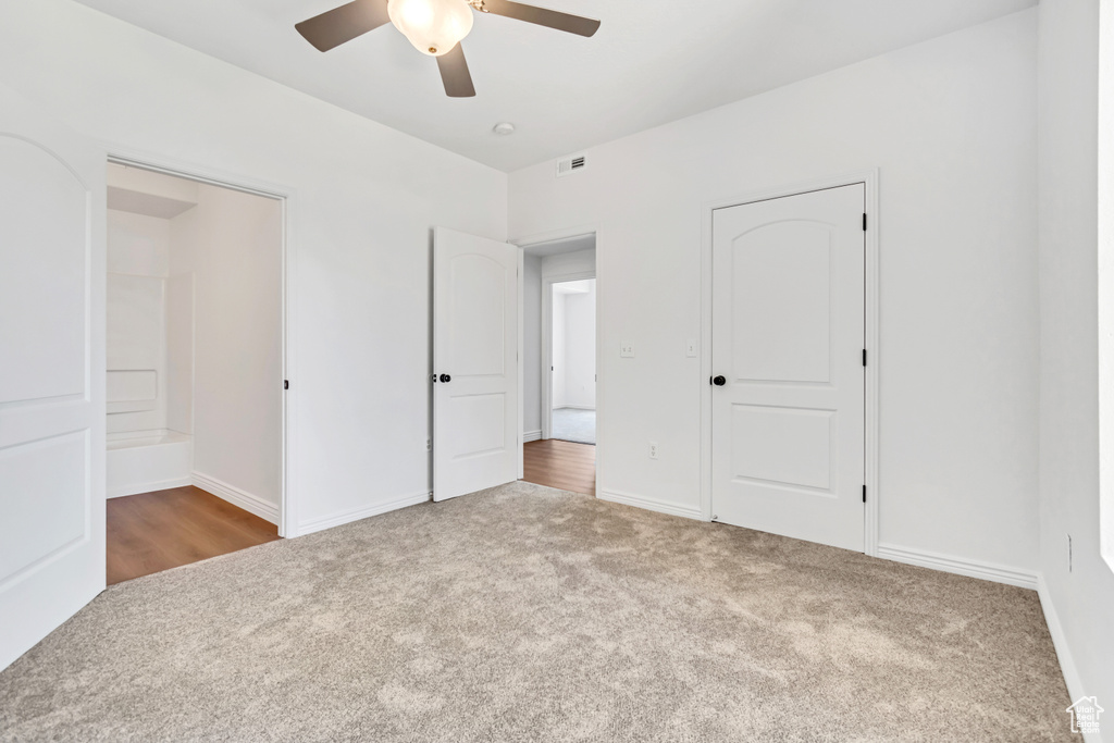 Unfurnished bedroom featuring carpet floors, baseboards, and ceiling fan