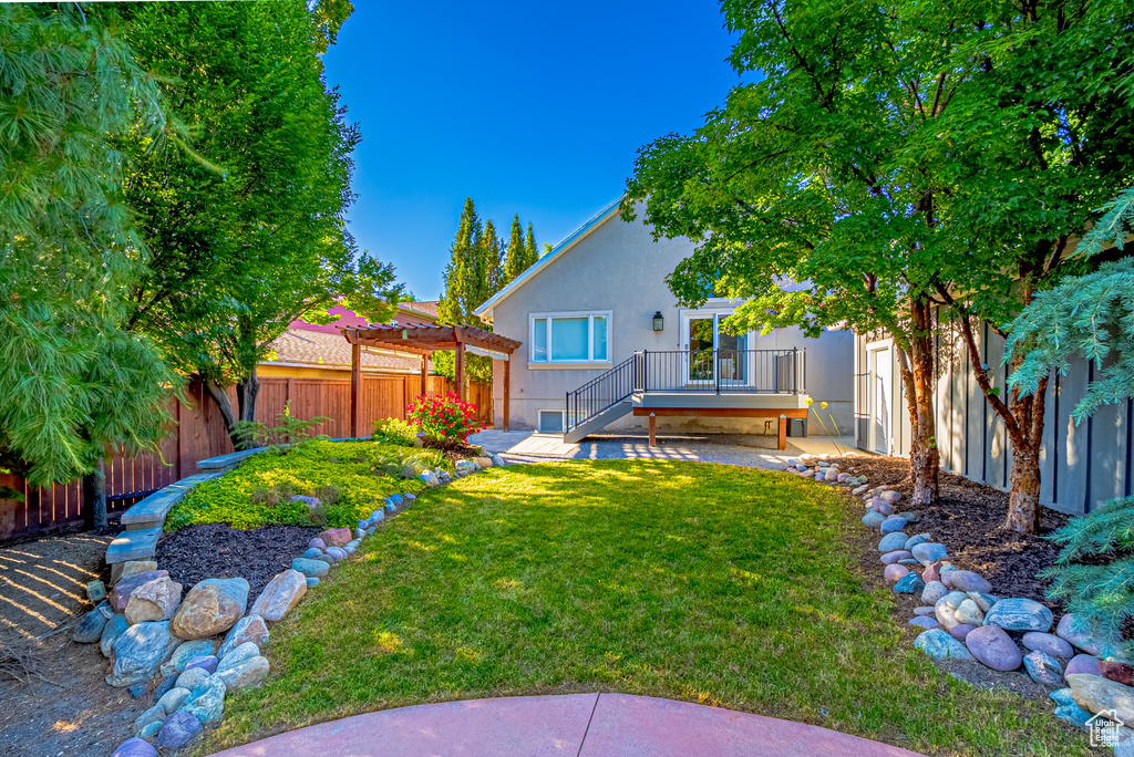 View of yard featuring a pergola and a deck