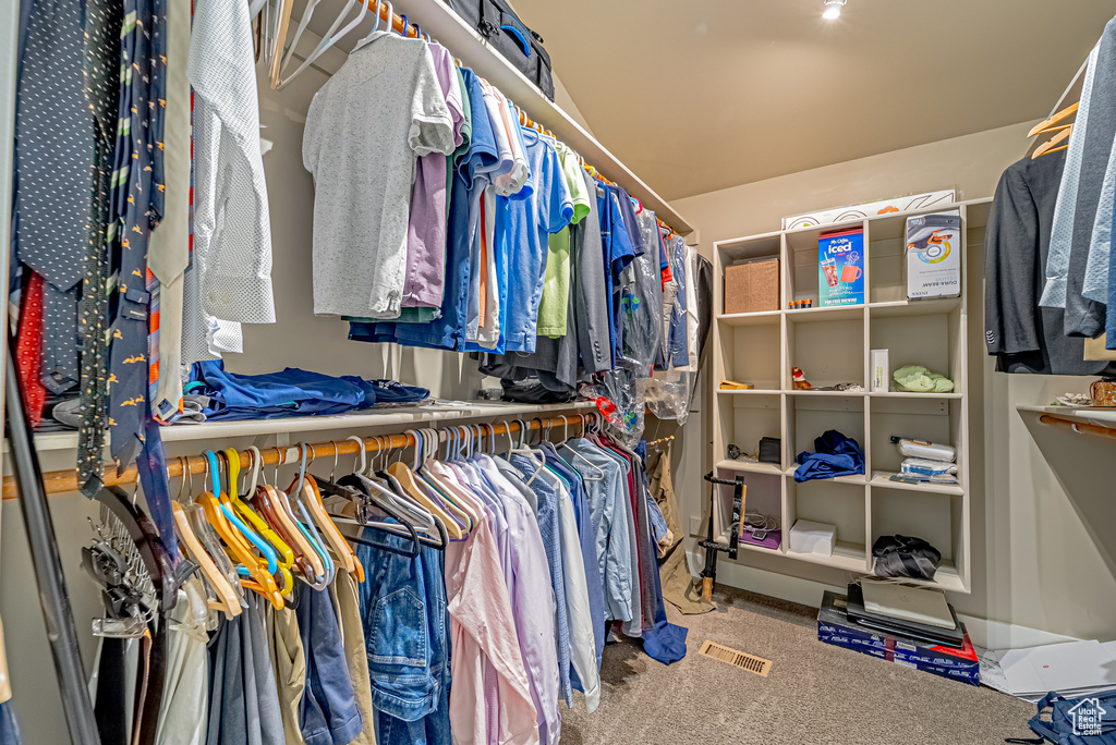 Walk in closet with carpet floors