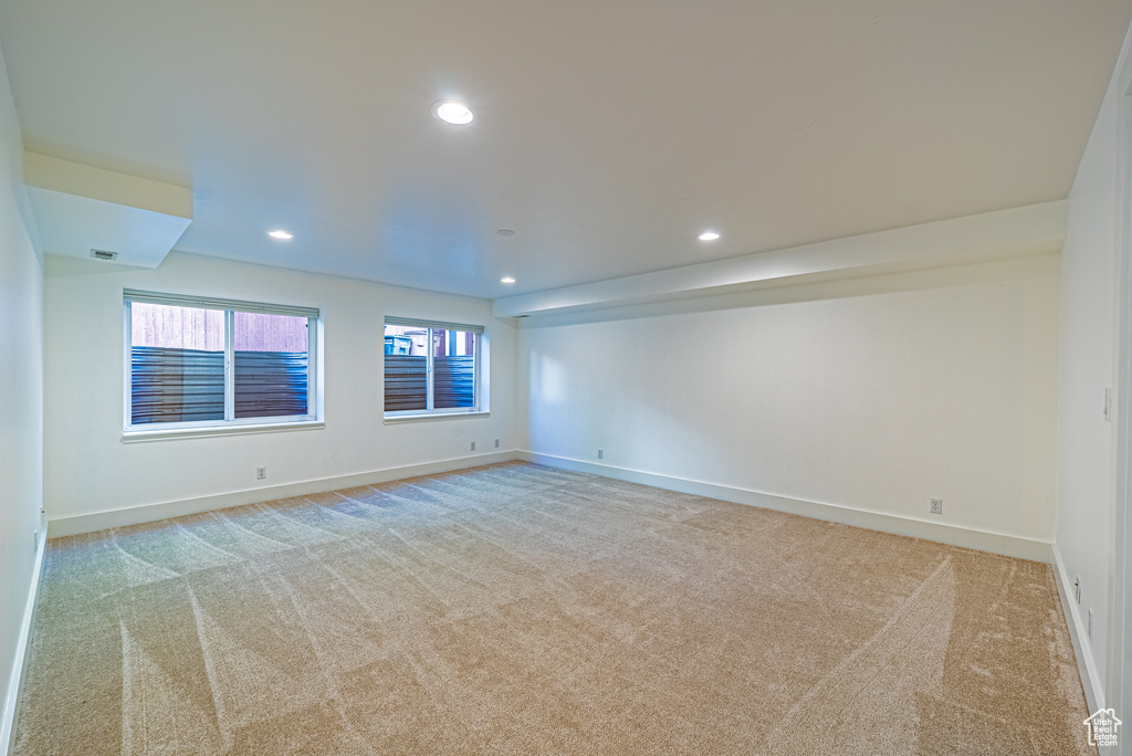 Unfurnished room featuring light colored carpet, baseboards, and recessed lighting