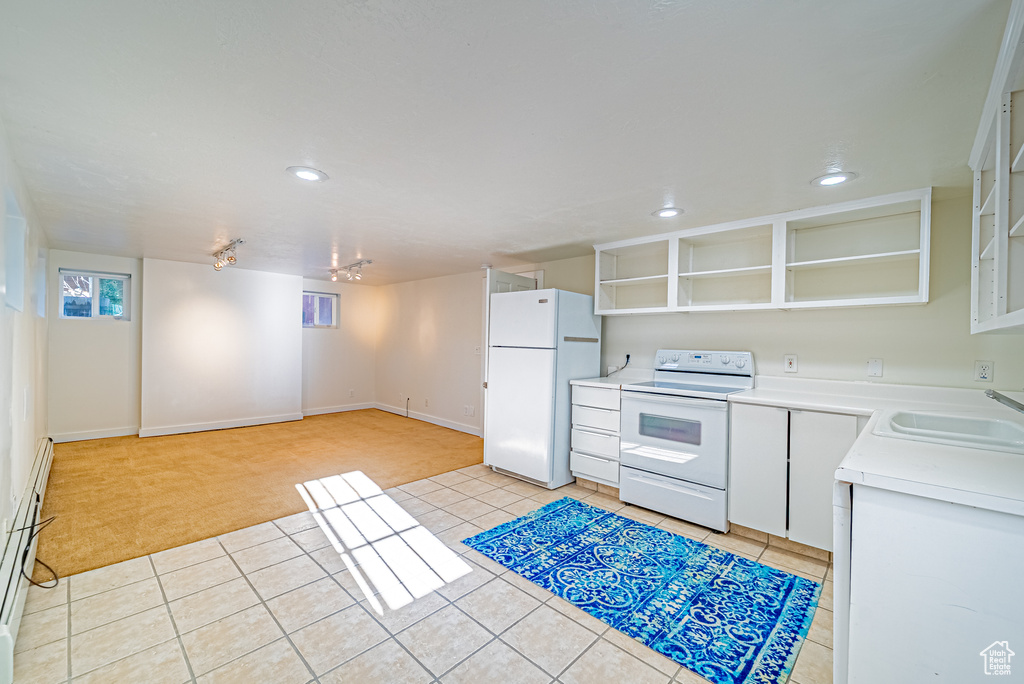 Kitchen with white appliances, open shelves, a sink, light colored carpet, and recessed lighting
