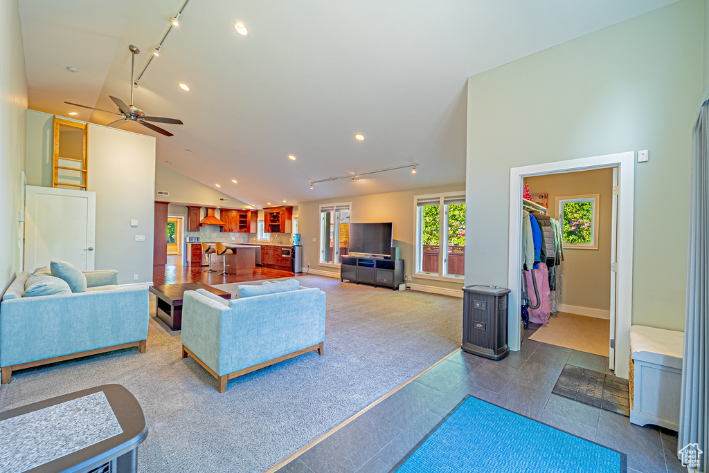 Living room featuring vaulted ceiling, recessed lighting, track lighting, a ceiling fan, and baseboards