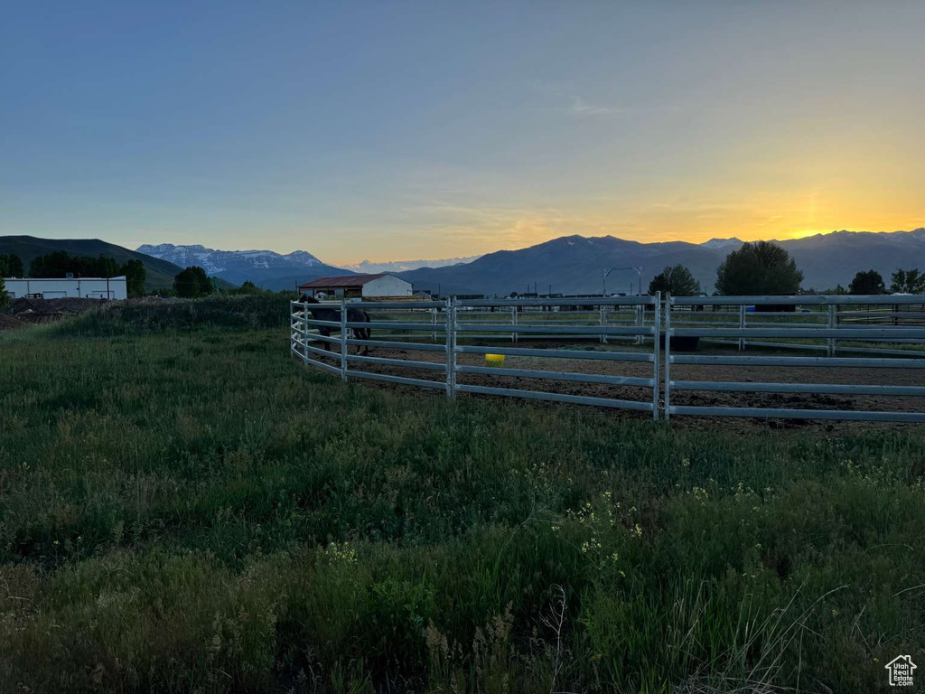 Yard at dusk featuring a mountain view
