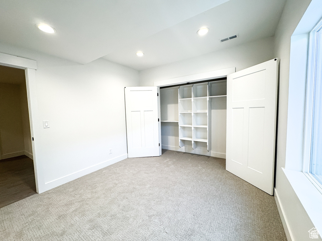 Unfurnished bedroom featuring carpet, recessed lighting, baseboards, and a closet