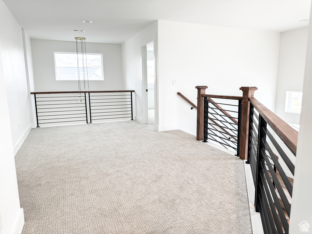Spare room featuring carpet floors, baseboards, and recessed lighting