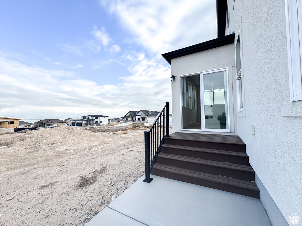 View of yard with entry steps and a residential view