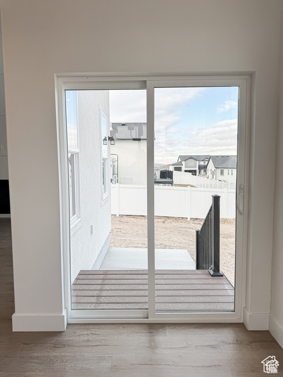 Entryway featuring baseboards and wood finished floors