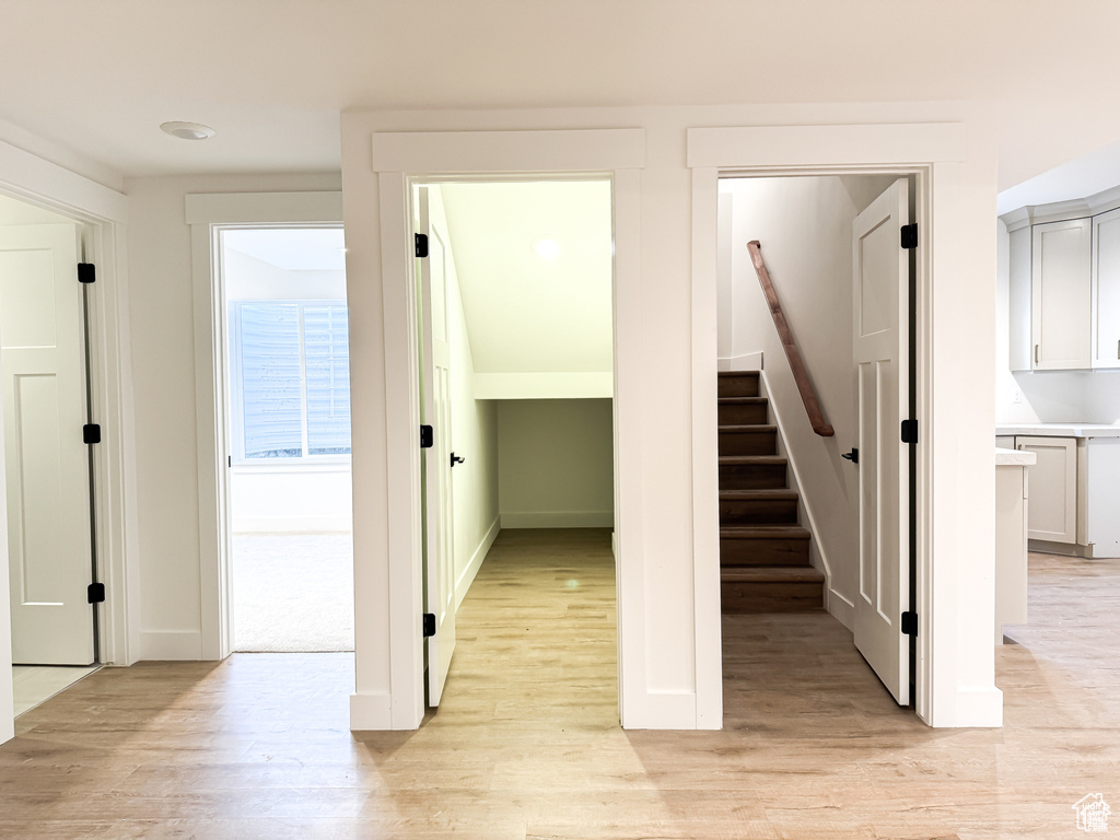 Stairway featuring wood finished floors and baseboards