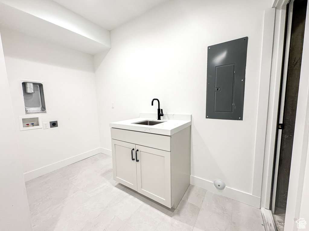 Laundry room featuring electric panel, hookup for an electric dryer, washer hookup, and baseboards