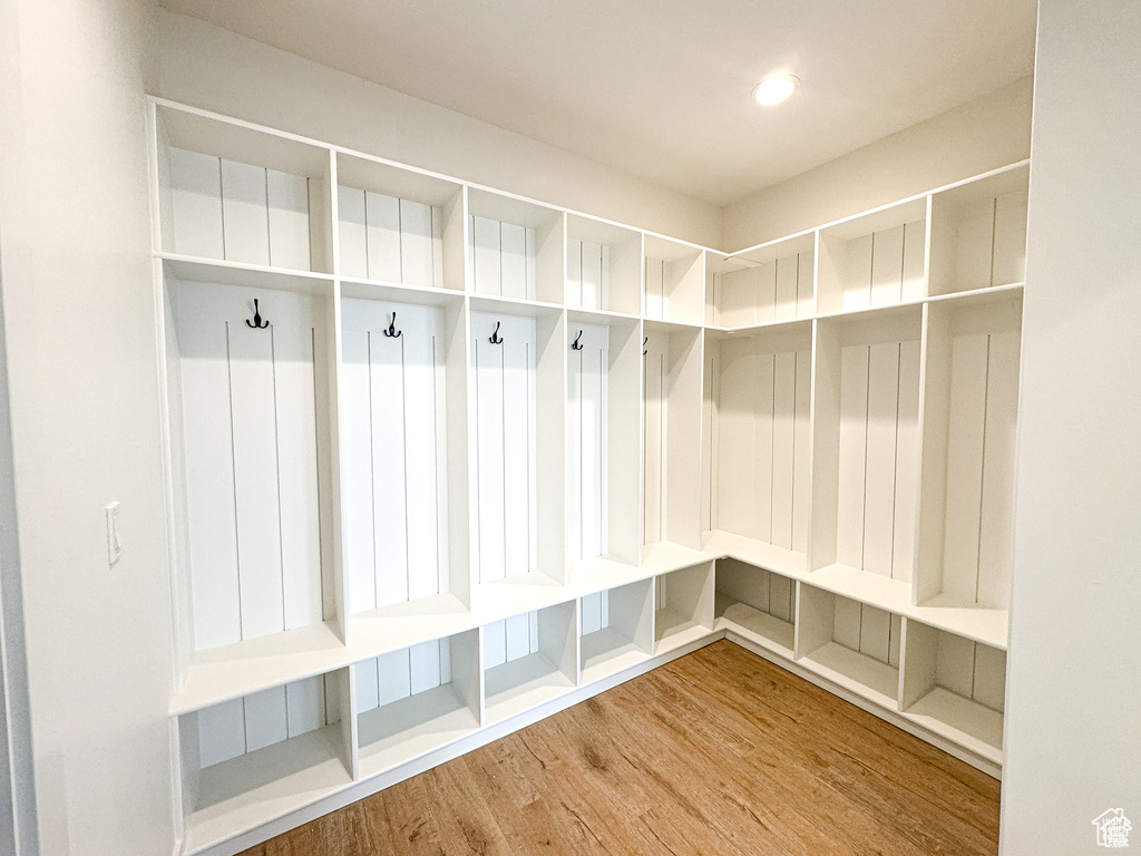 Mudroom with wood finished floors and recessed lighting